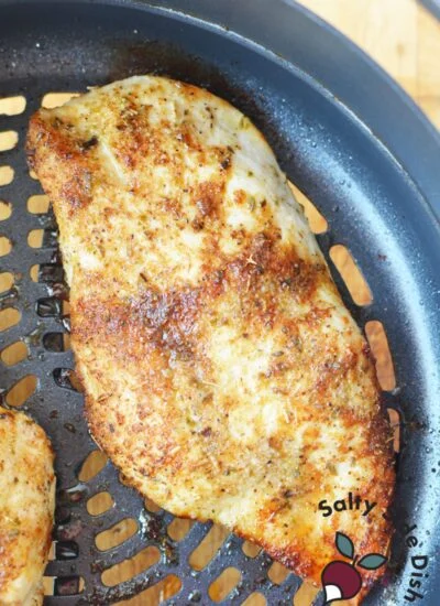 piece of cooked chicken in air crisp basket.