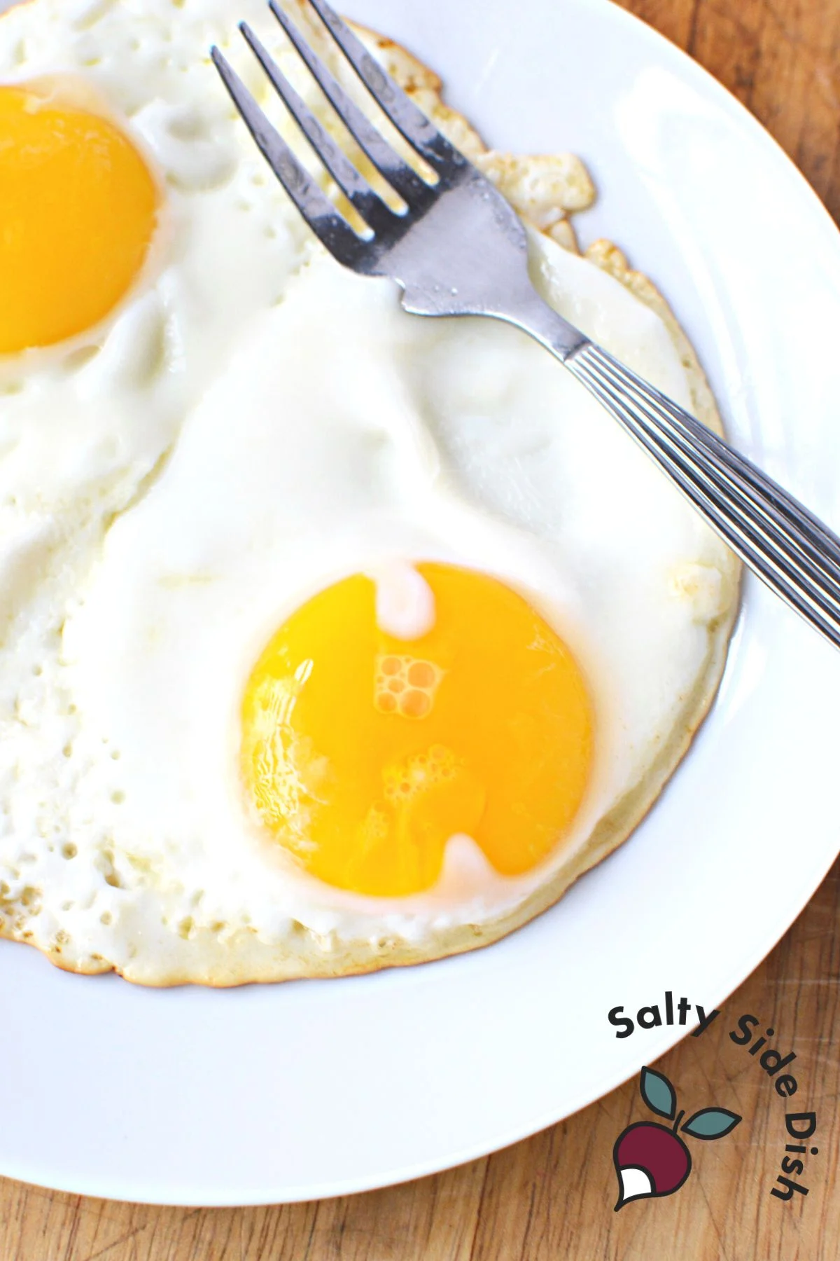 Sunny side up eggs on a plate.