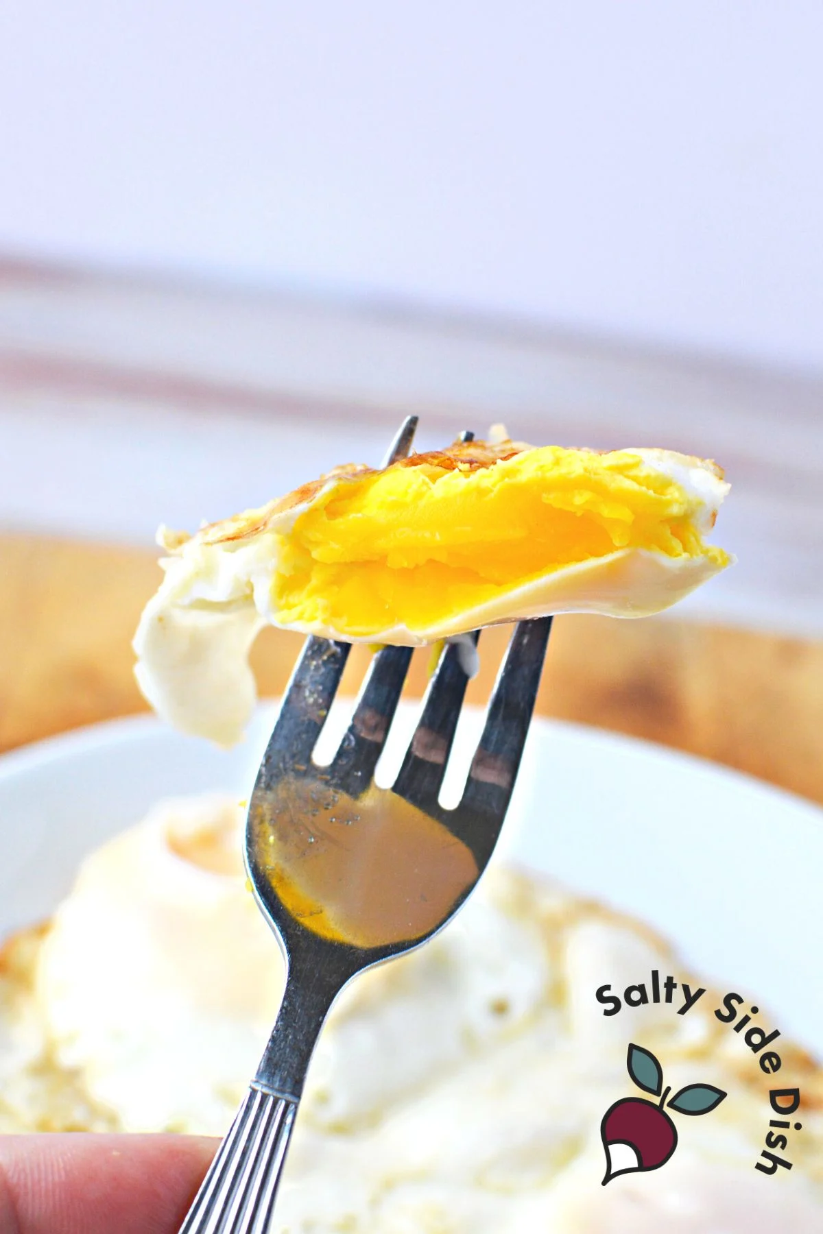 An over-hard egg on a fork.