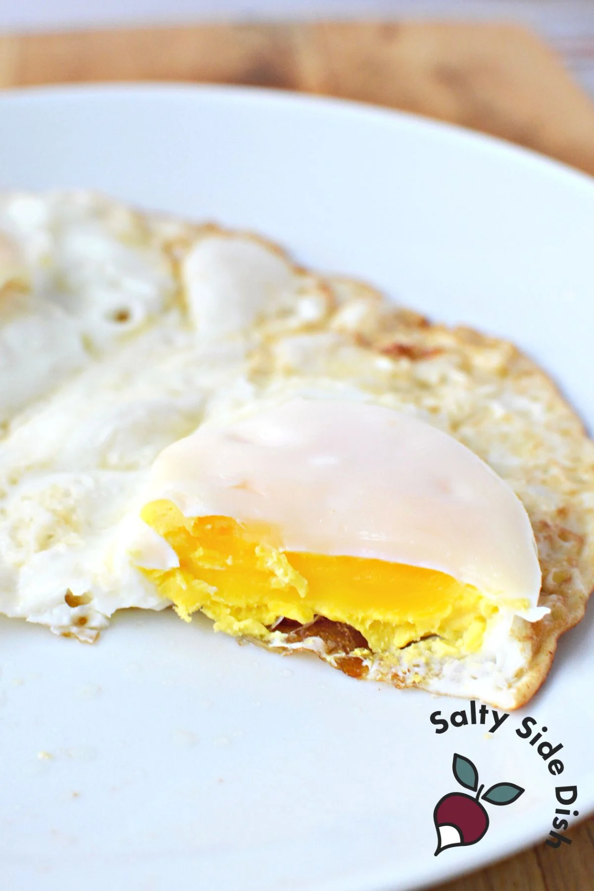 Over-hard eggs on a plate.