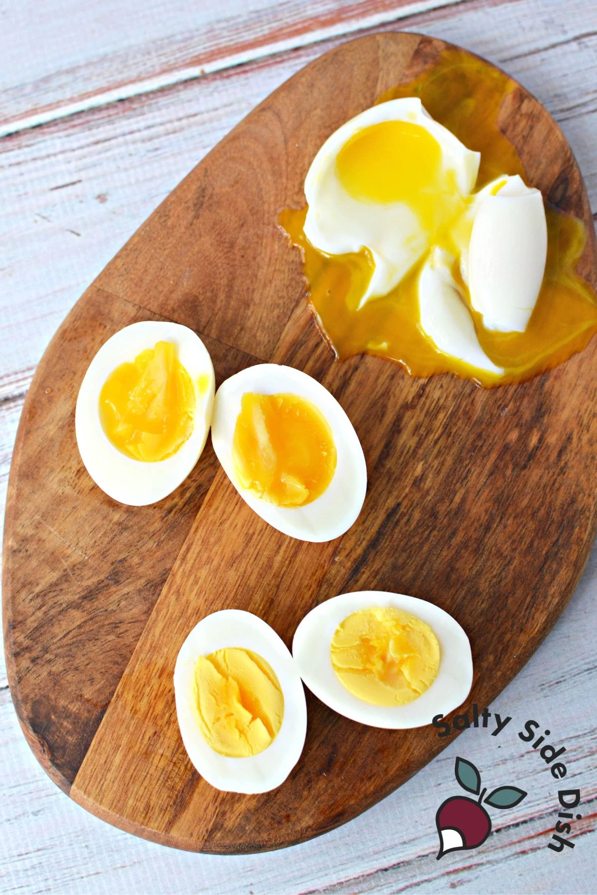 Three different sliced, boiled eggs on a cutting board.