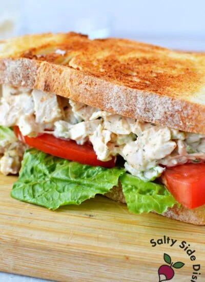 chicken salad sandwich half with lettuce and tomato.