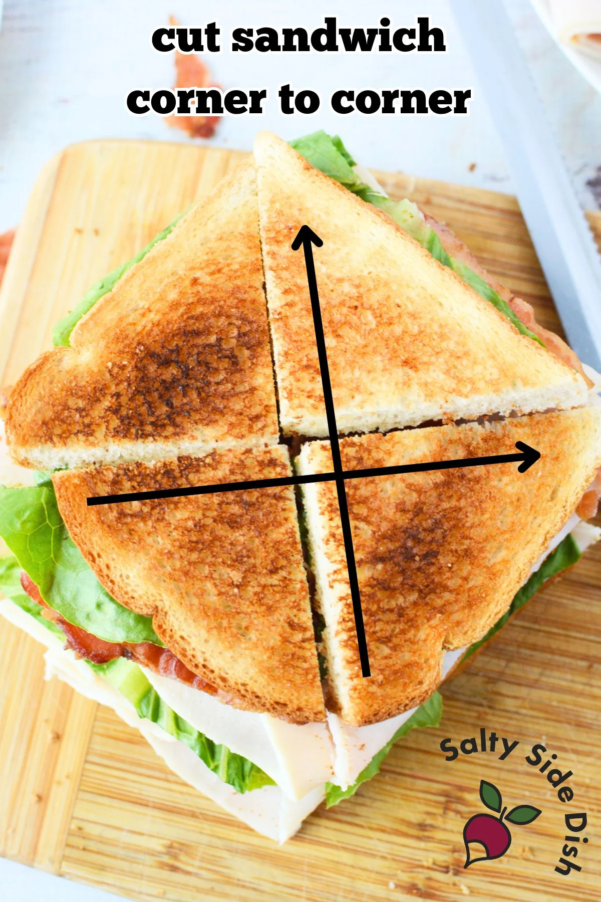cutting a club sandwich corner to corner.