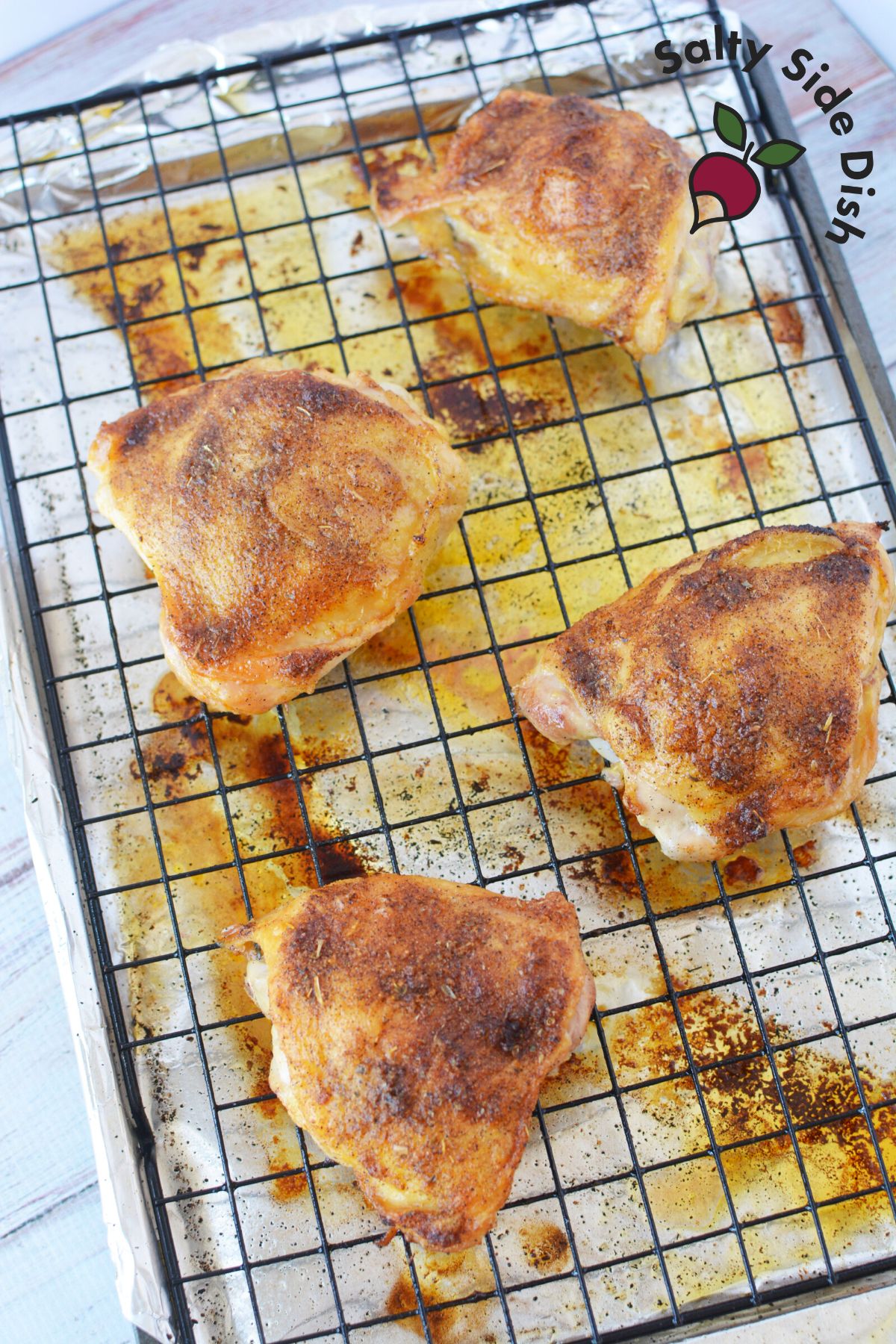 oven baked chicken thighs on a rack.