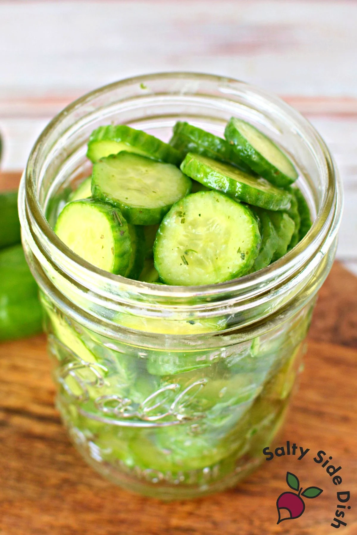 sliced cucumbers with ranch in a mason jar.