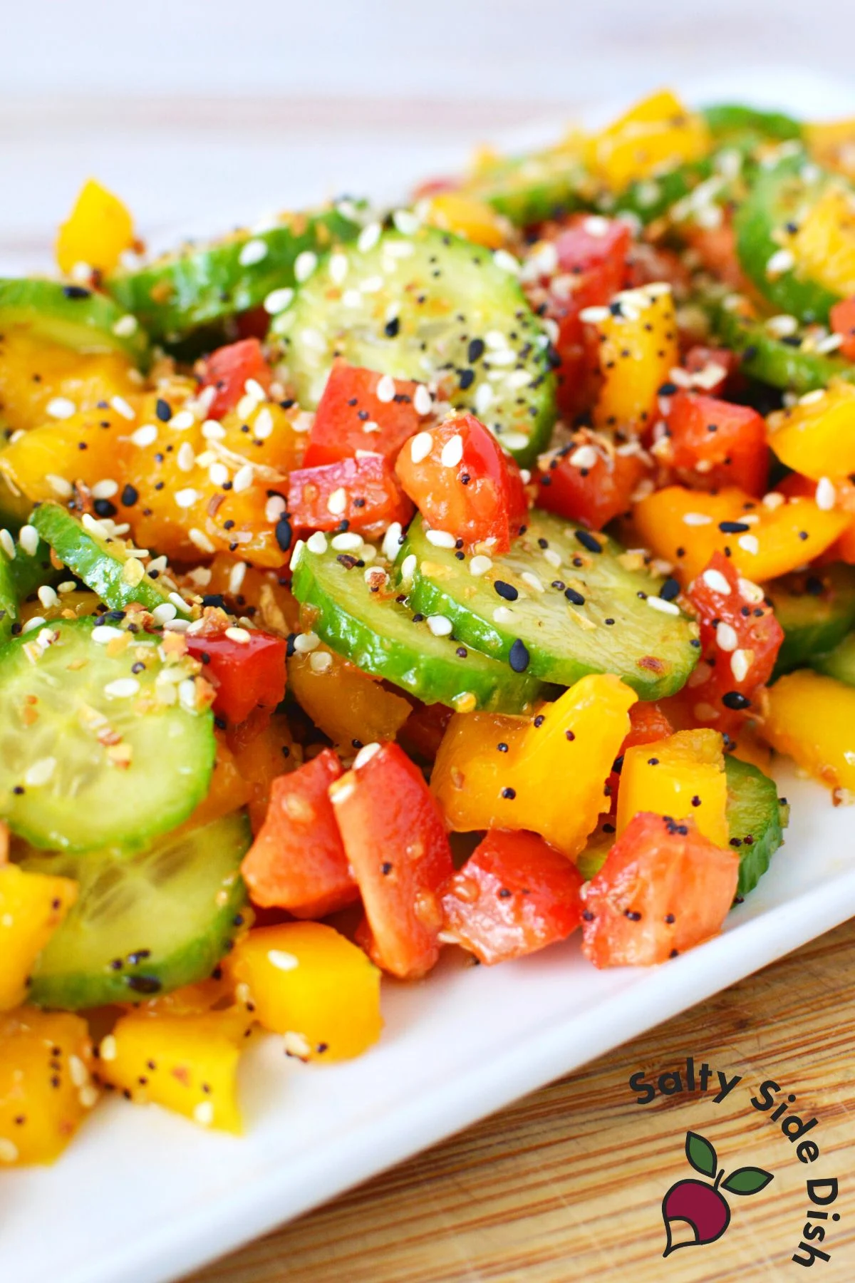 cucumber pepper salad on a white serving tray.