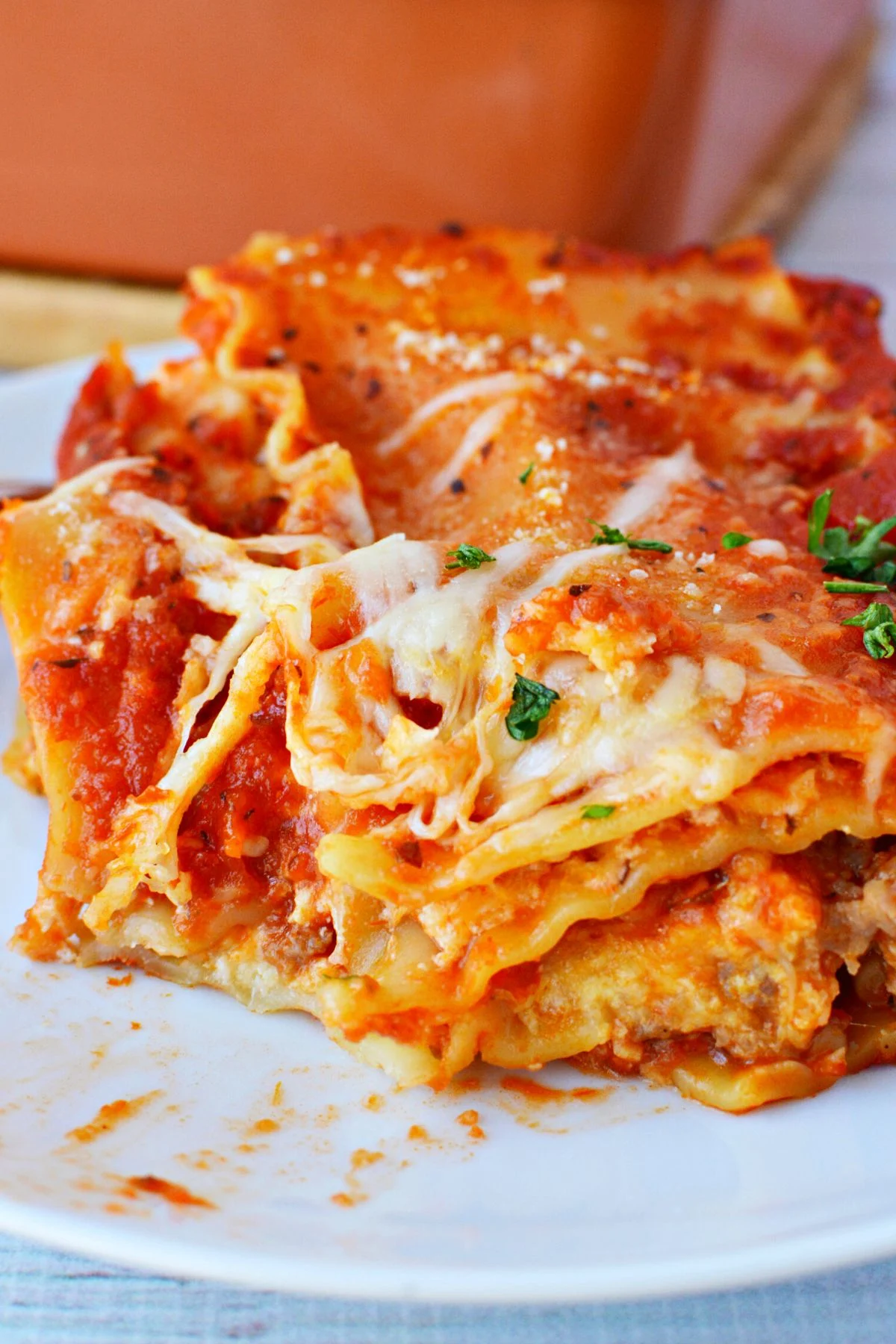 simple lasagna recipe with a big piece on a white plate.