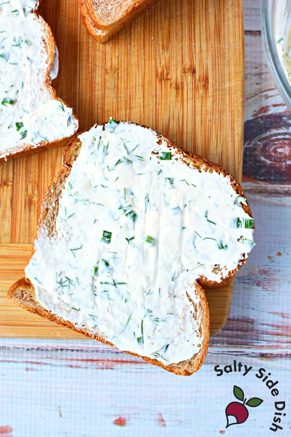 showing cream cheese mixture edge to edge on a piece of bread.