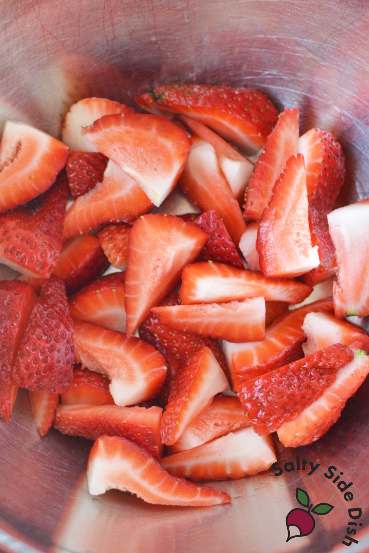 quartered strawberries in a bowl.