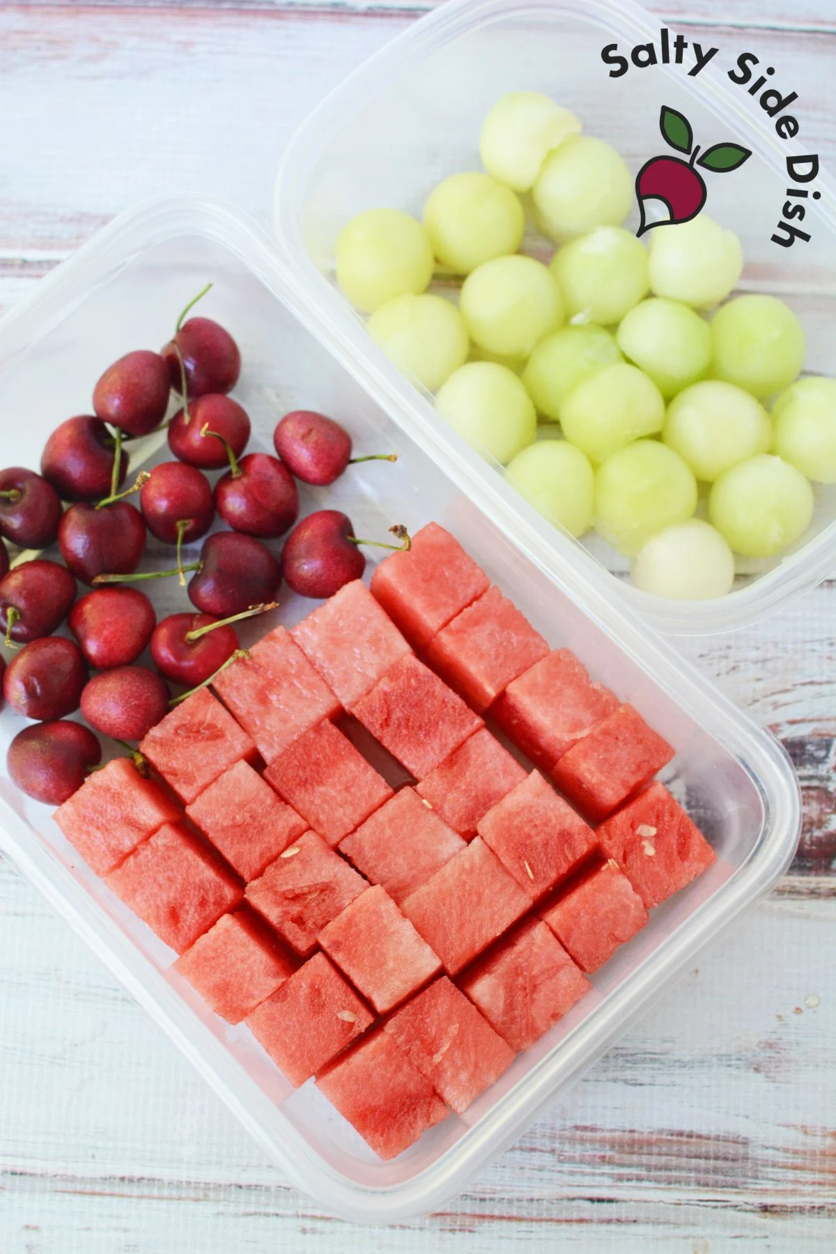 watermelon, cherries, and grapes in containers in a flat layer ready for mix.