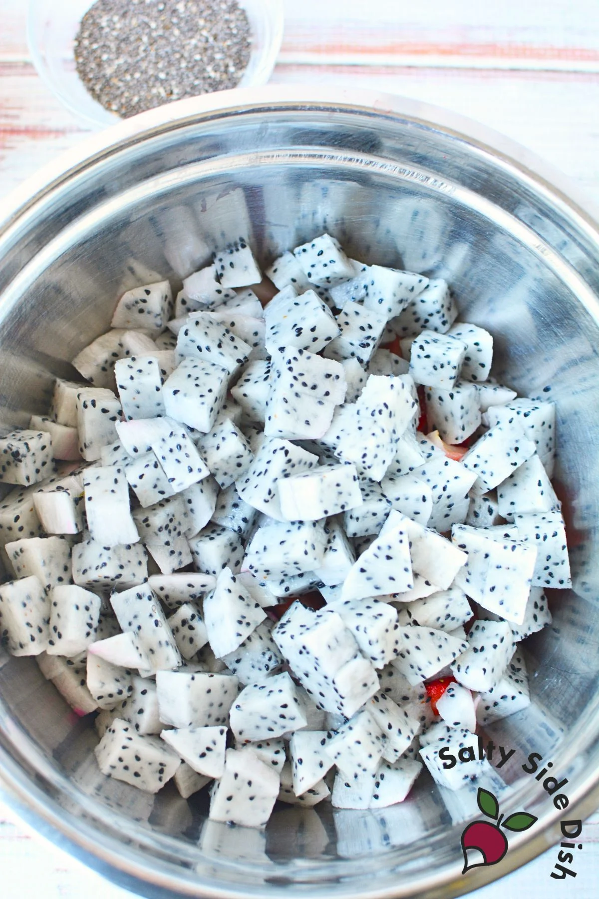 cutting up dragon fruit for tropical salad.