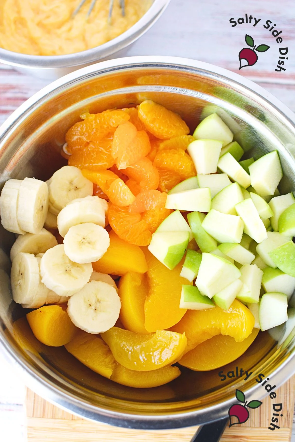 Freshly chopped fruits and drained canned fruits for fruit salad.