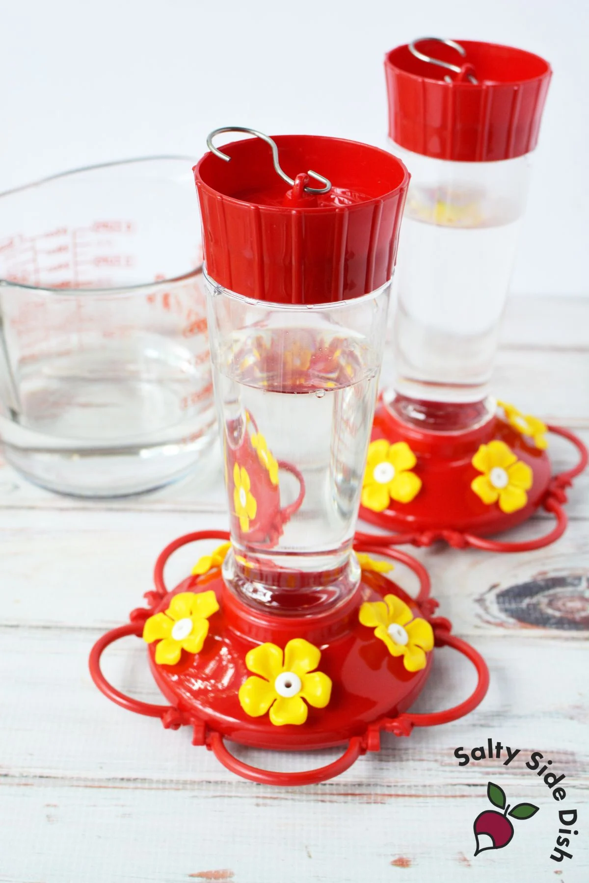 full hummingbird feeder that is fool of the food I made.