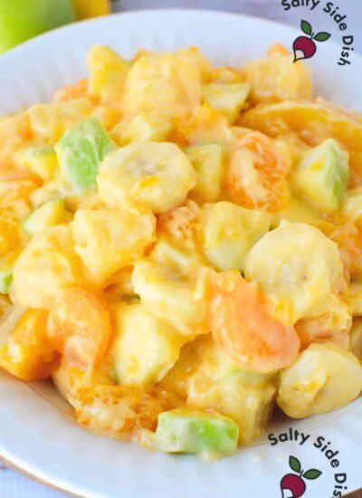 dreamlike fruit salad with oranges and creamy sweet dessert dressing with pudding and yogurt.