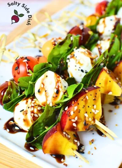 finished skewers ready to eat, piled on a white plate for a gathering.