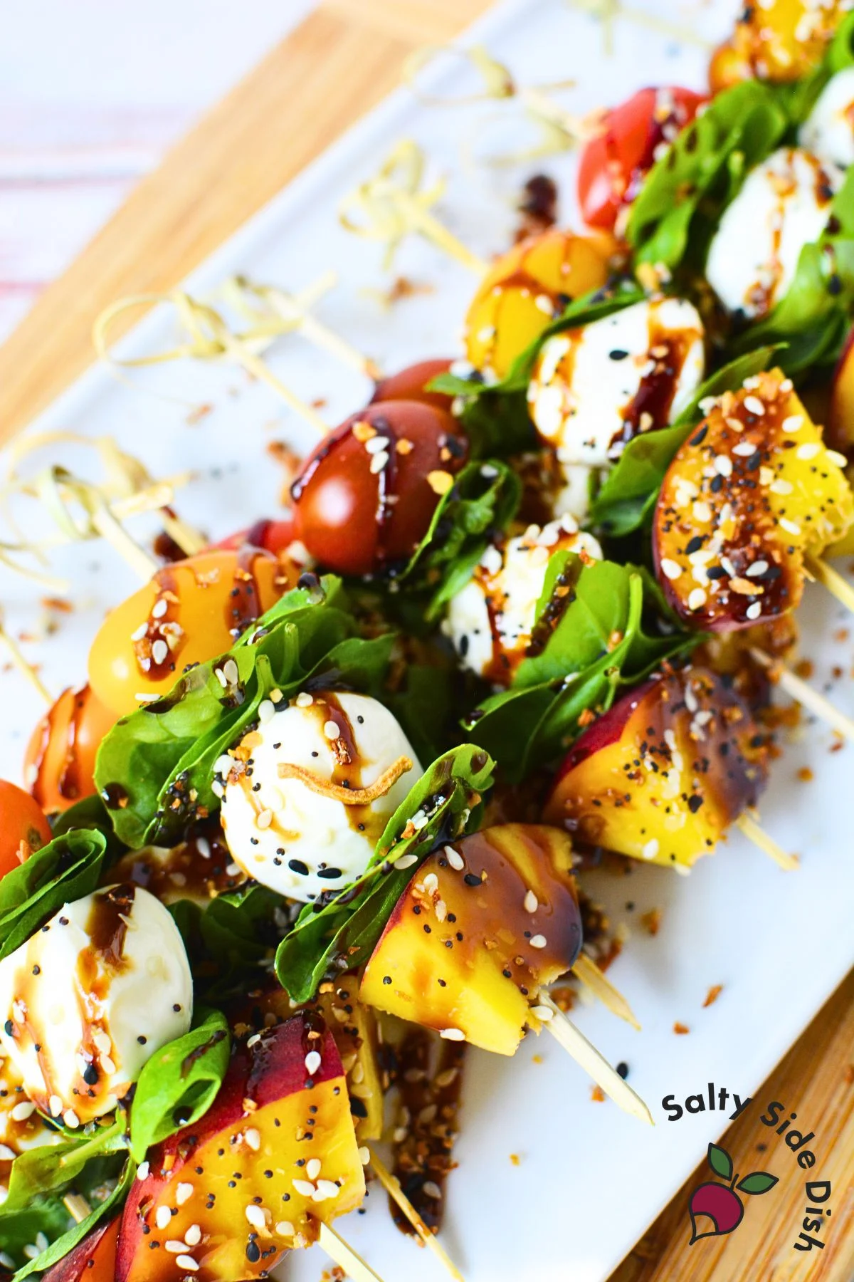 how to make peach caprese skewers with tomatoes, basil, mozzarella, and fresh seasonal peaches.