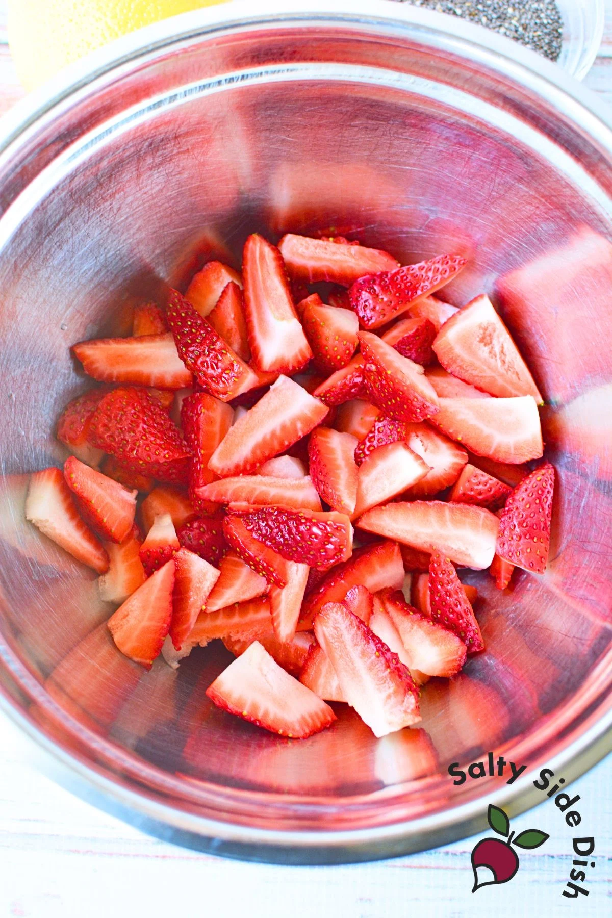 quartered strawberries in a mixing bowl.