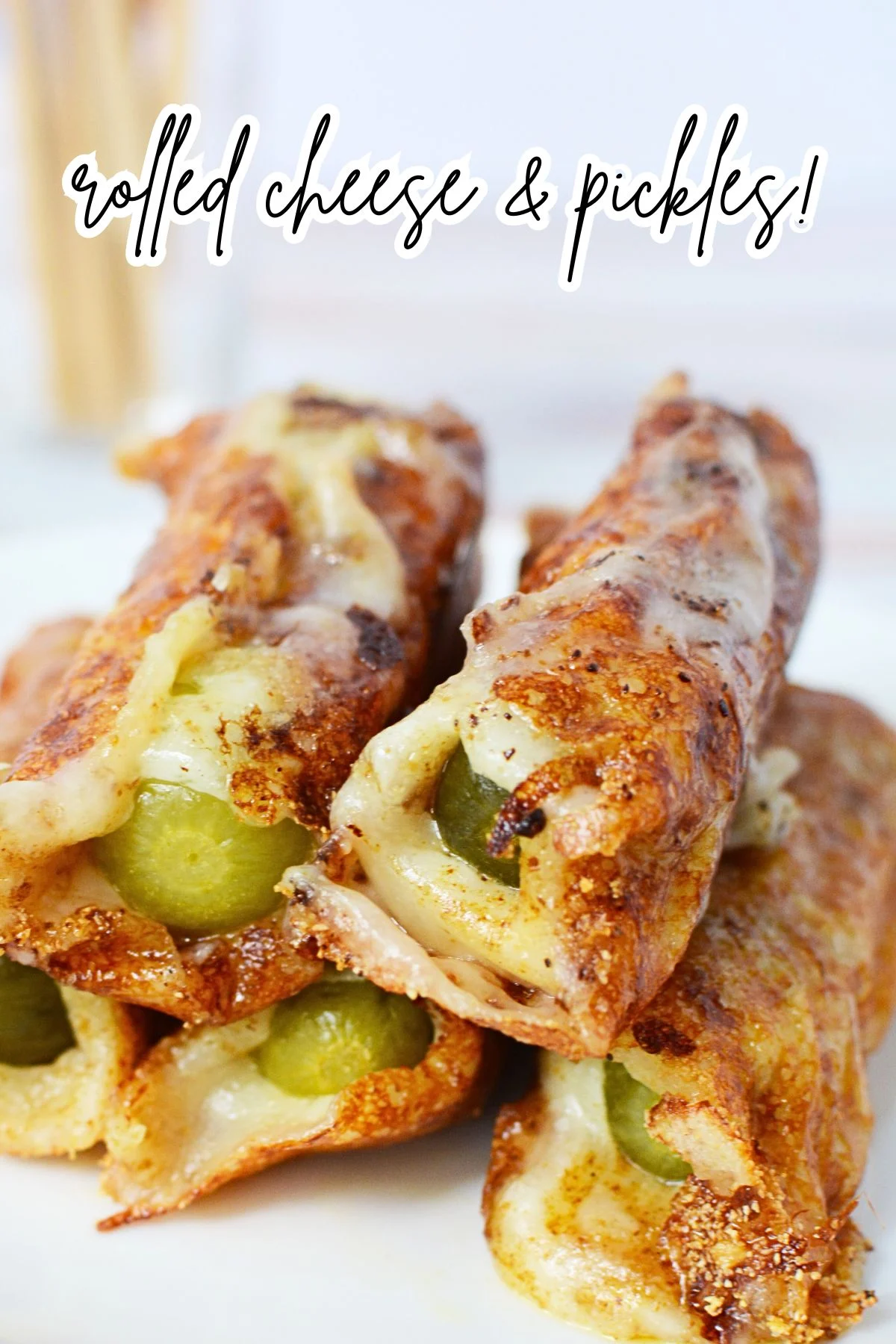 Cheese-wrapped pickles draining on paper towels.