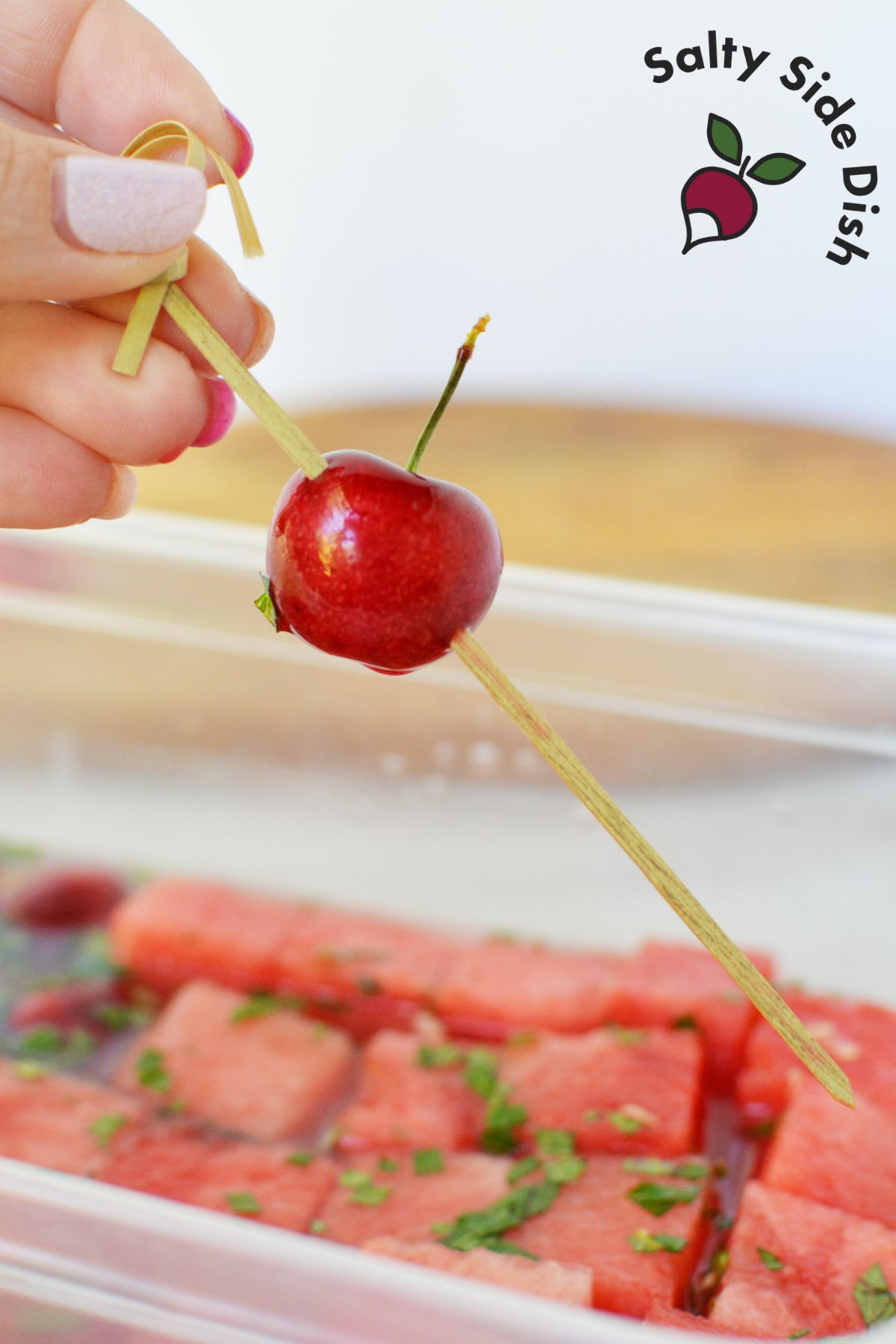 add skewers through the cherry but in front of the pitt.