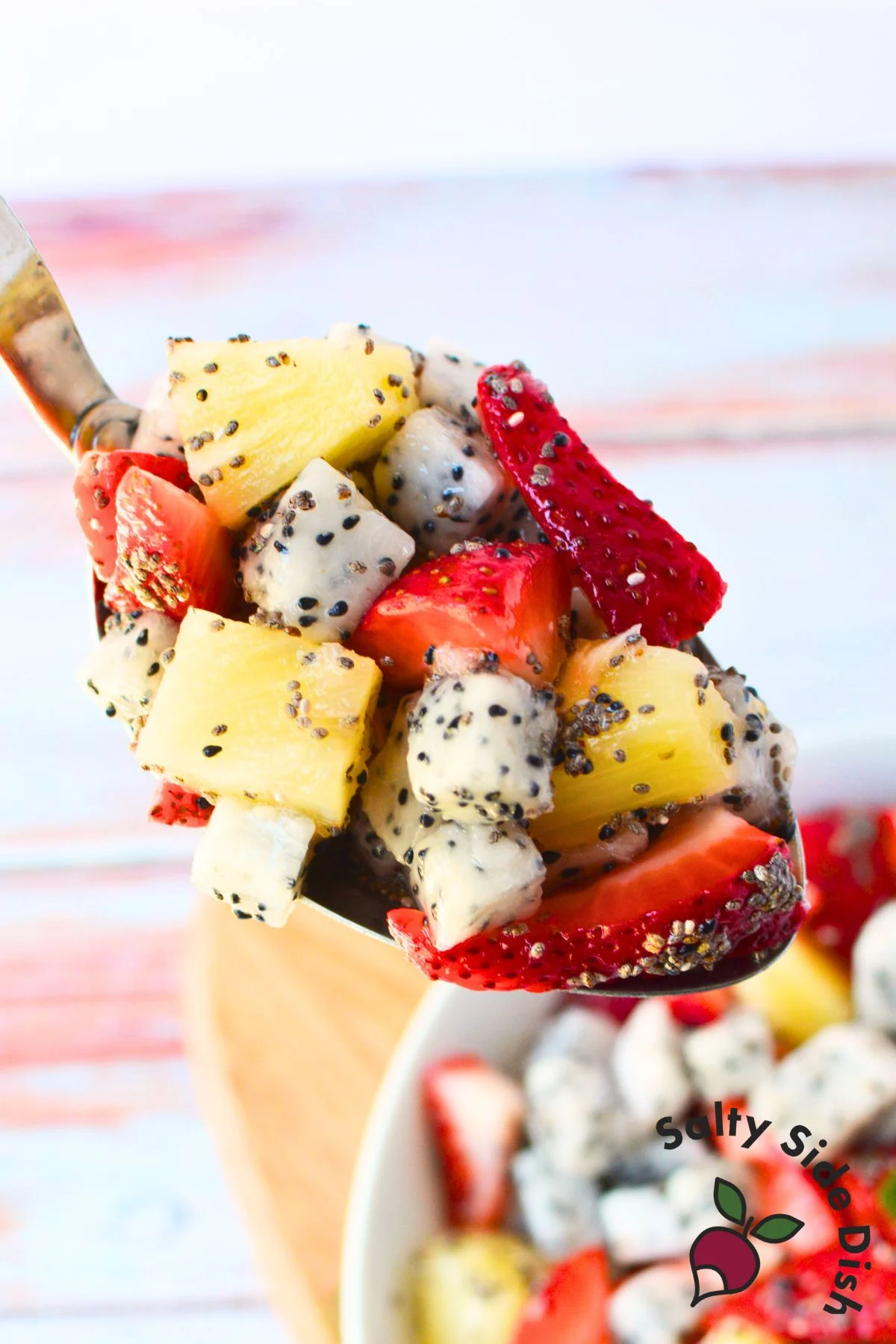 tropical fruit salad on a spoon.