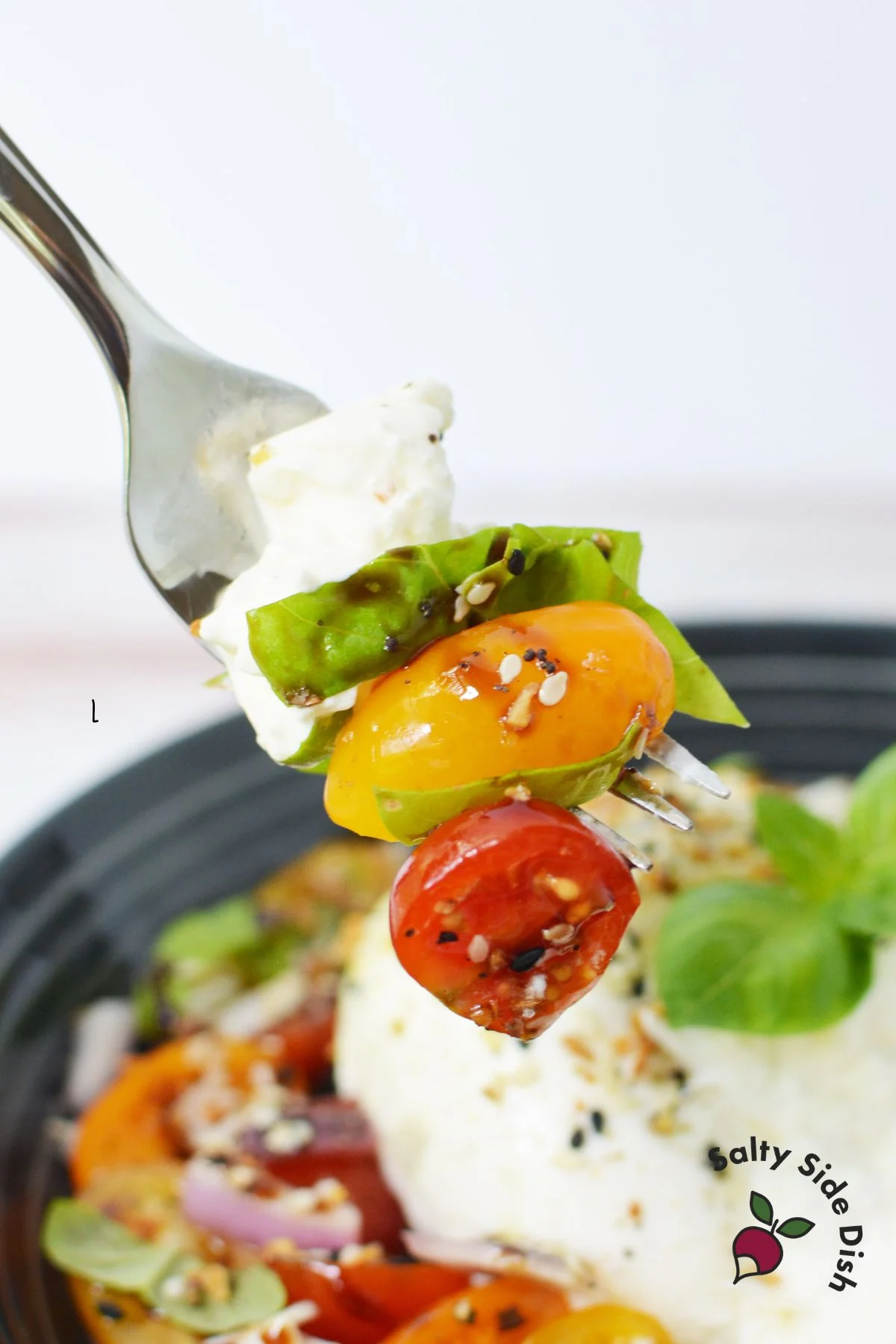 a forkful of salad stacked with each ingredient.