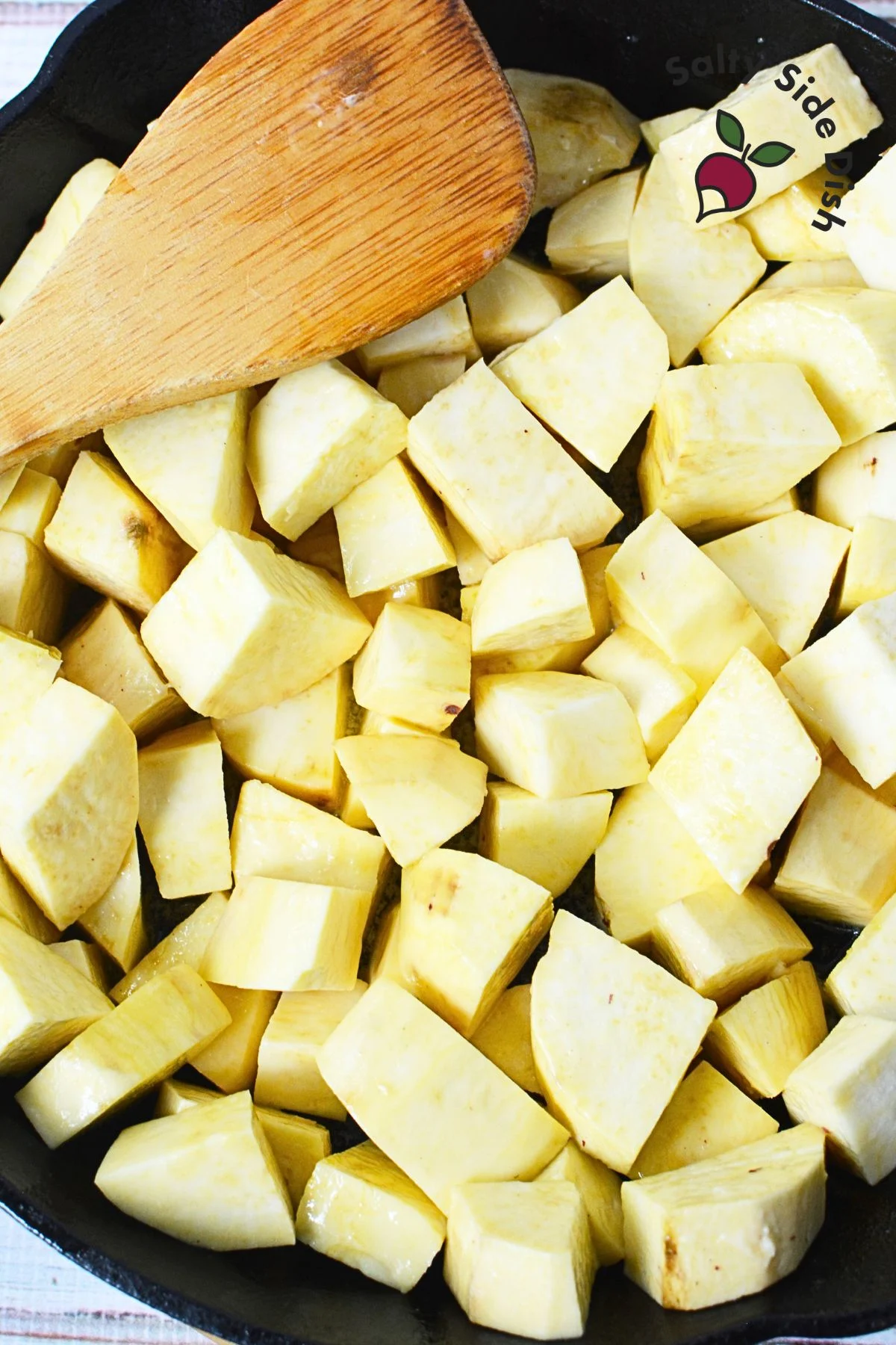 chunks of yams in a cast iron pan.