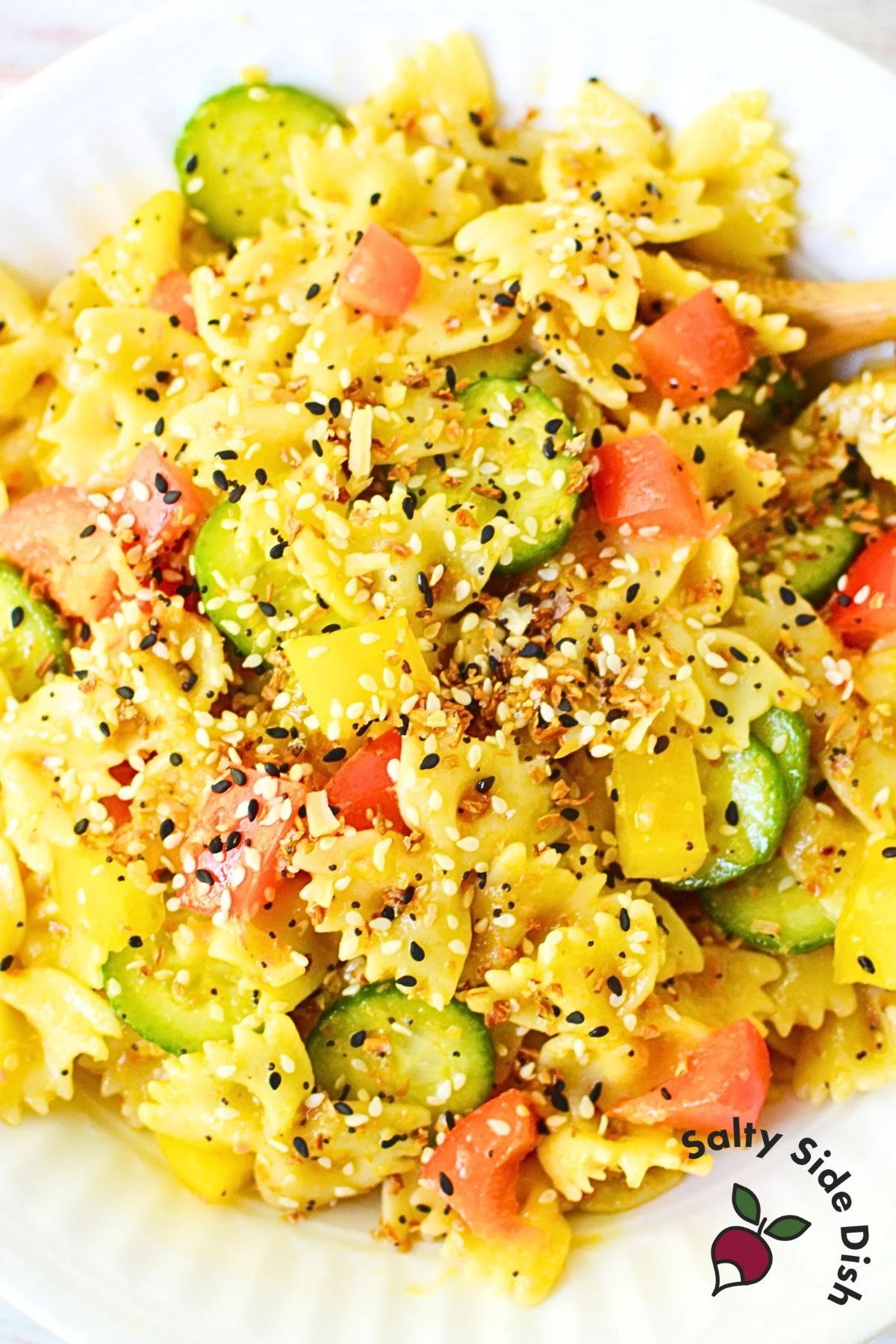 Close-up of vibrant cucumber and bell pepper pasta salad