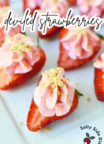 Deviled cheesecake strawberries on a dessert tray.