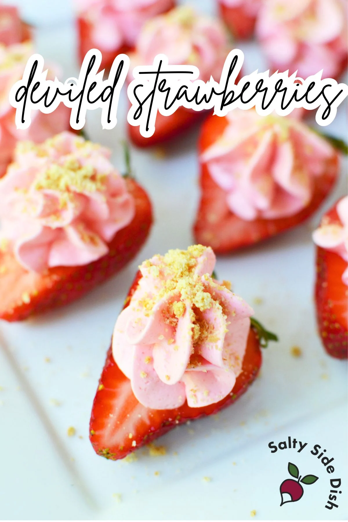 Deviled cheesecake strawberries on a dessert tray.