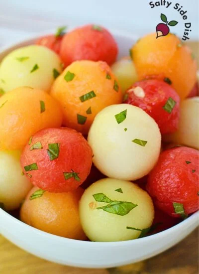 melon ball fruit salad recipe in a white bowl.