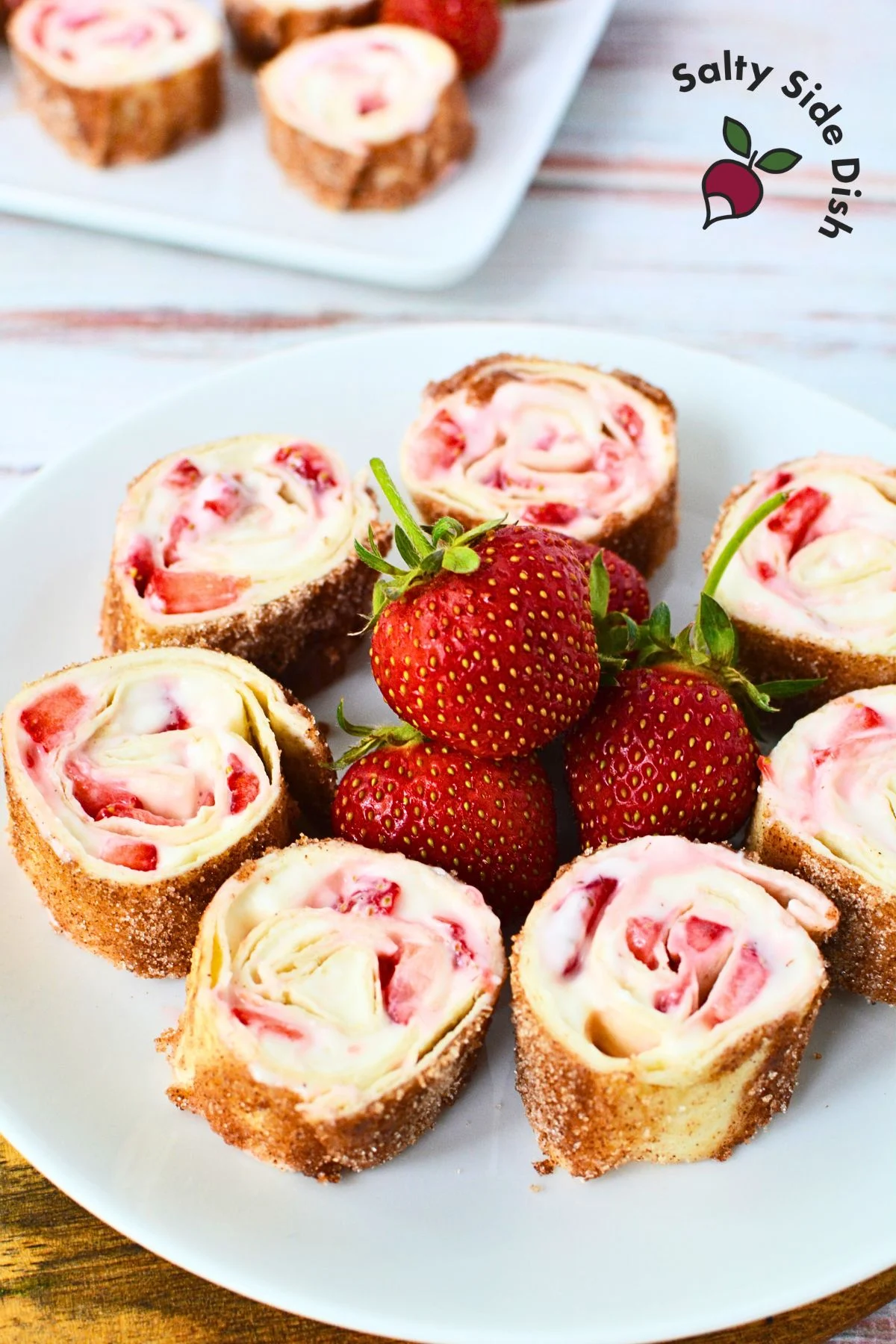 plate of strawberry rollups with cheesecake tortillas.