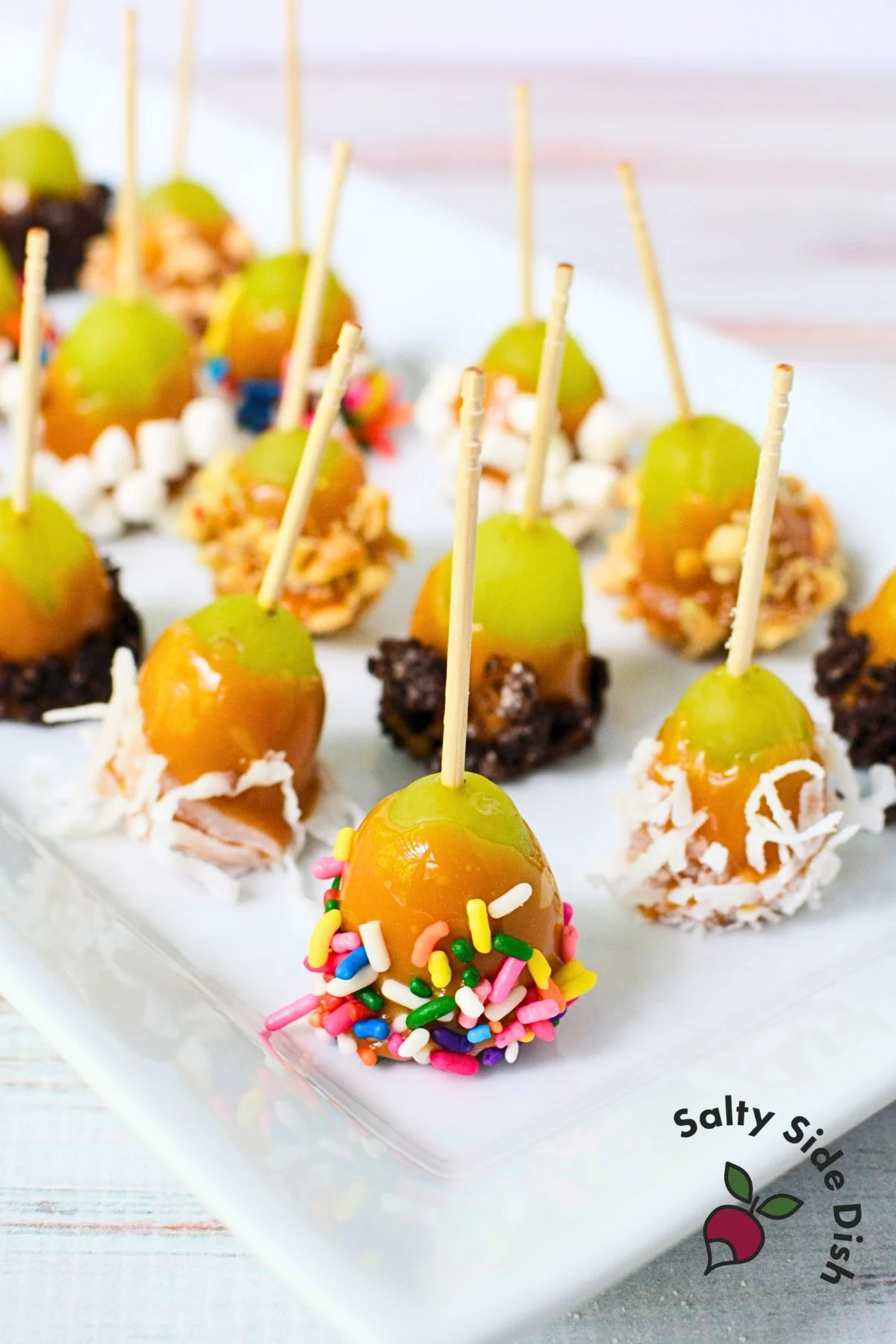 Close-up of caramel-dipped grapes with sprinkles.