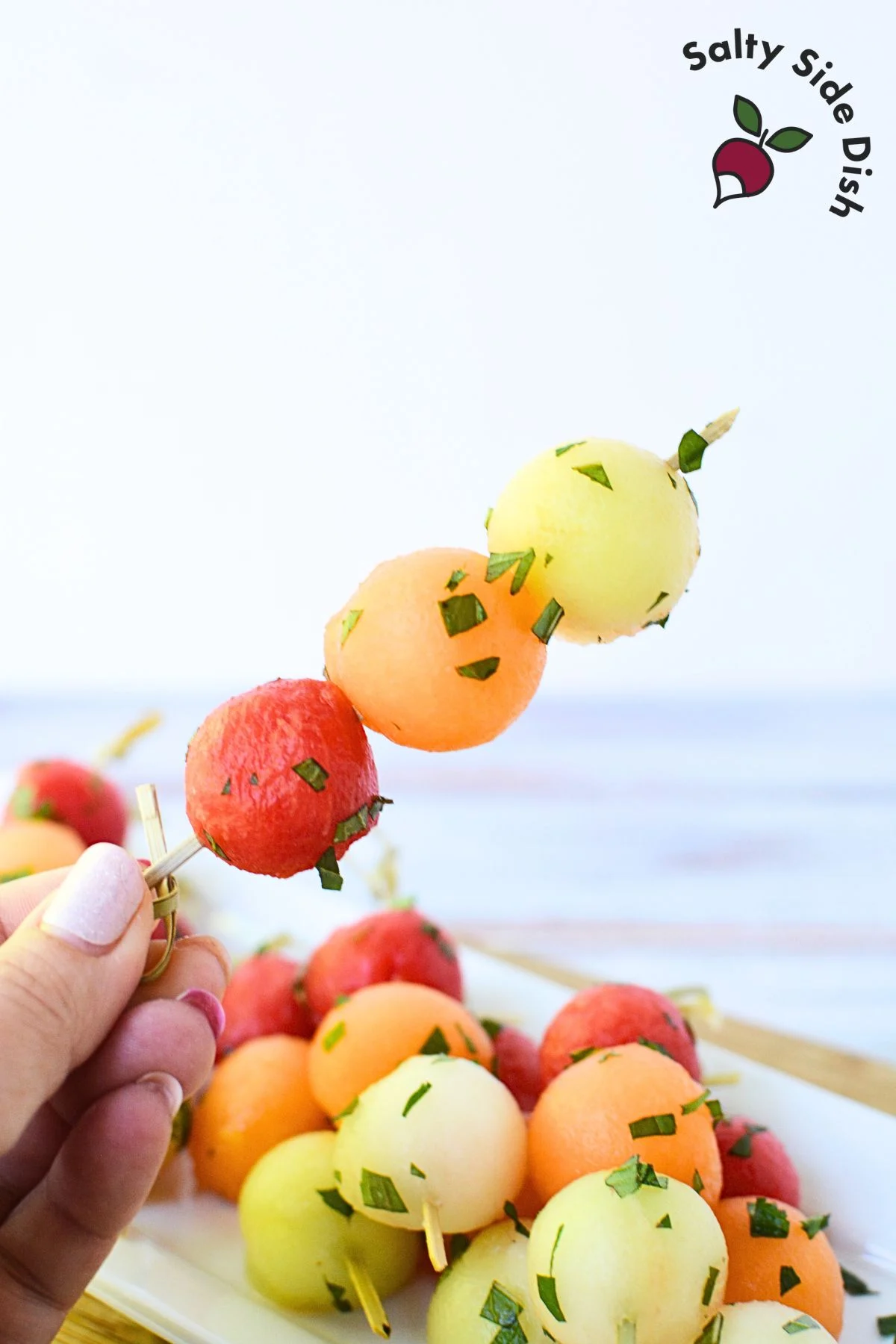 3 types of melons on a fruit skewer.