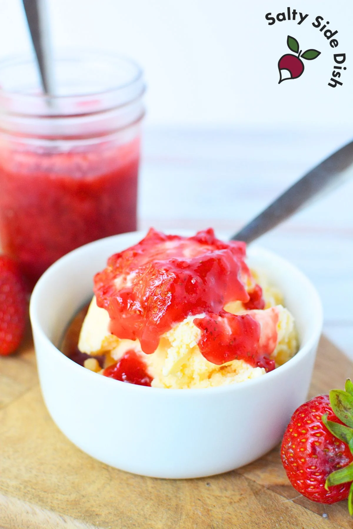 homemade strawberry topping sauce recipe over a banana split.