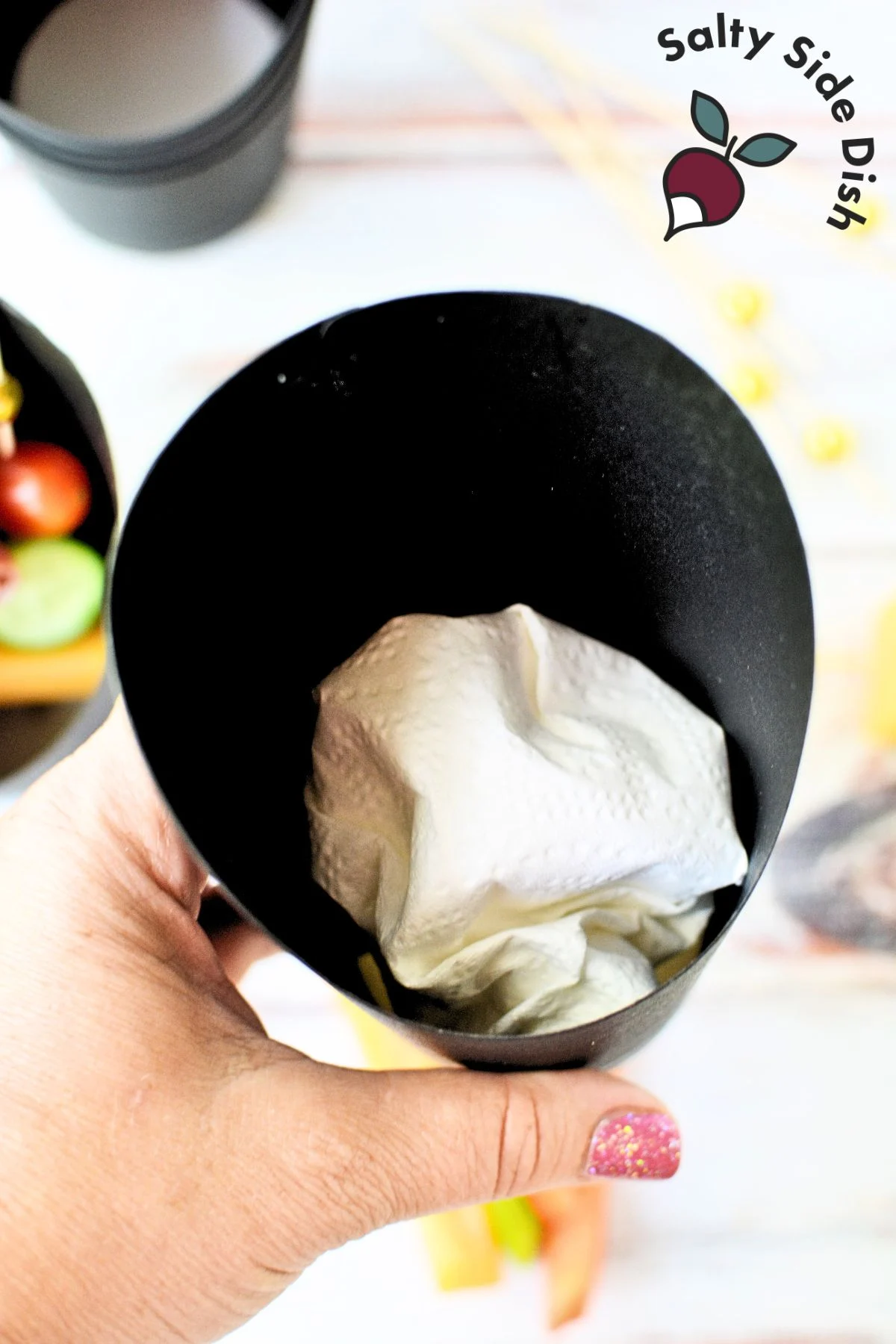 add a napkin to the bottom of the paper cups to elevate food.