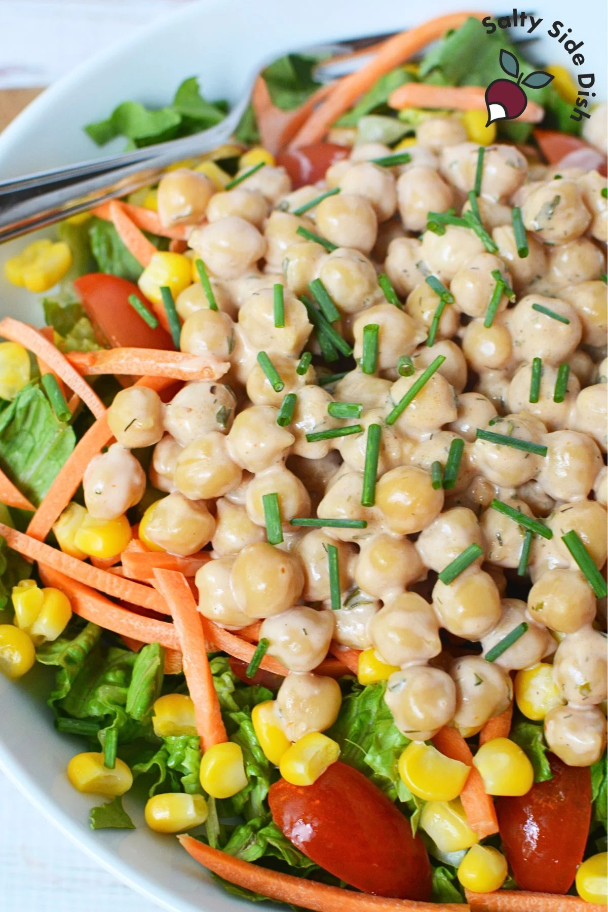 simple warm salad recipe with chickpeas and chopped salad ingredients.