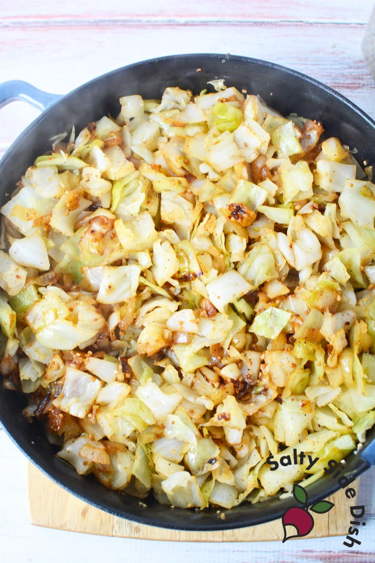 cooking down cabbage in a skillet.
