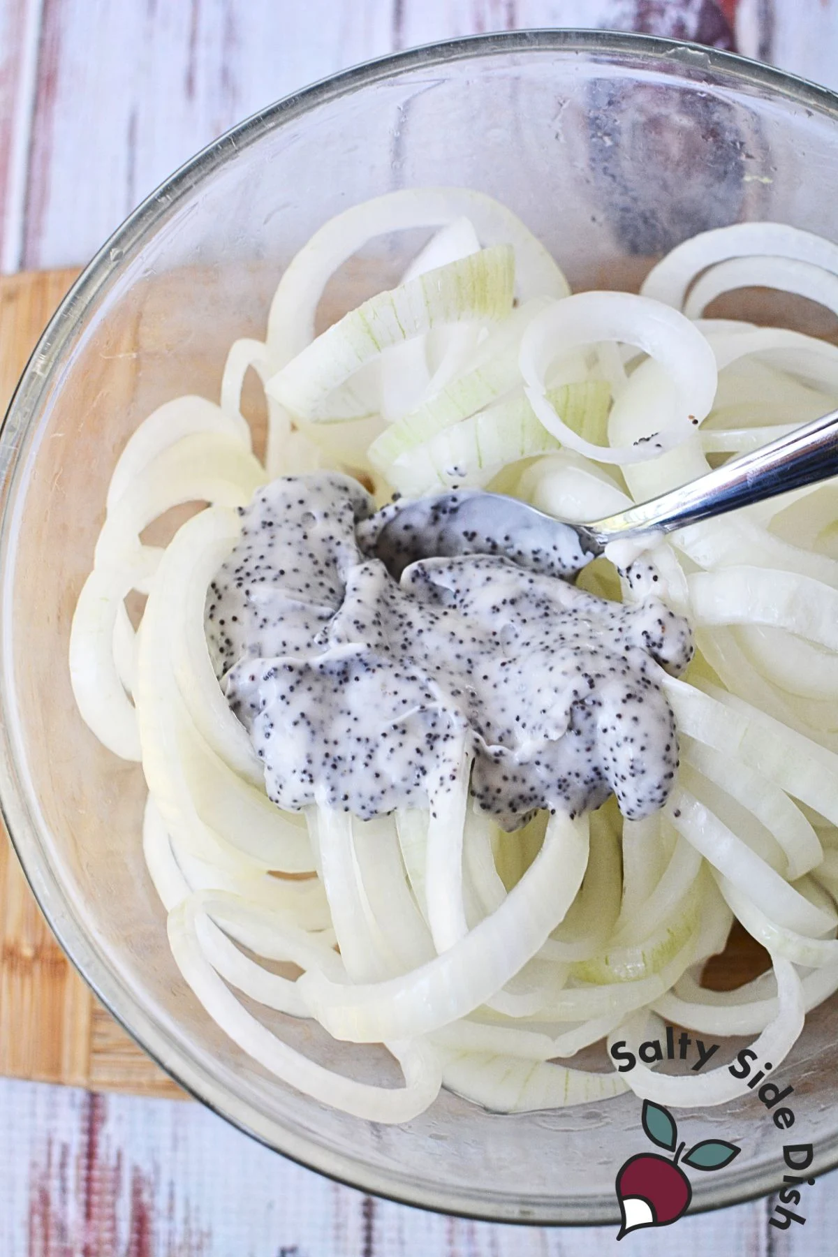 Stirring the creamy dressing into the onions for a delicious salad.