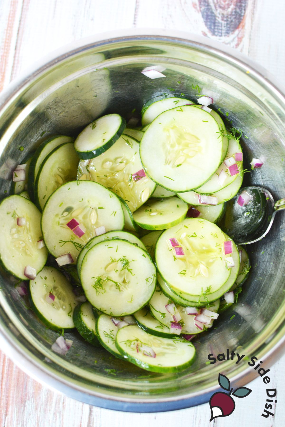 This salad recipe is an easy cucumber side dish and is sitting in a mixing bowl.