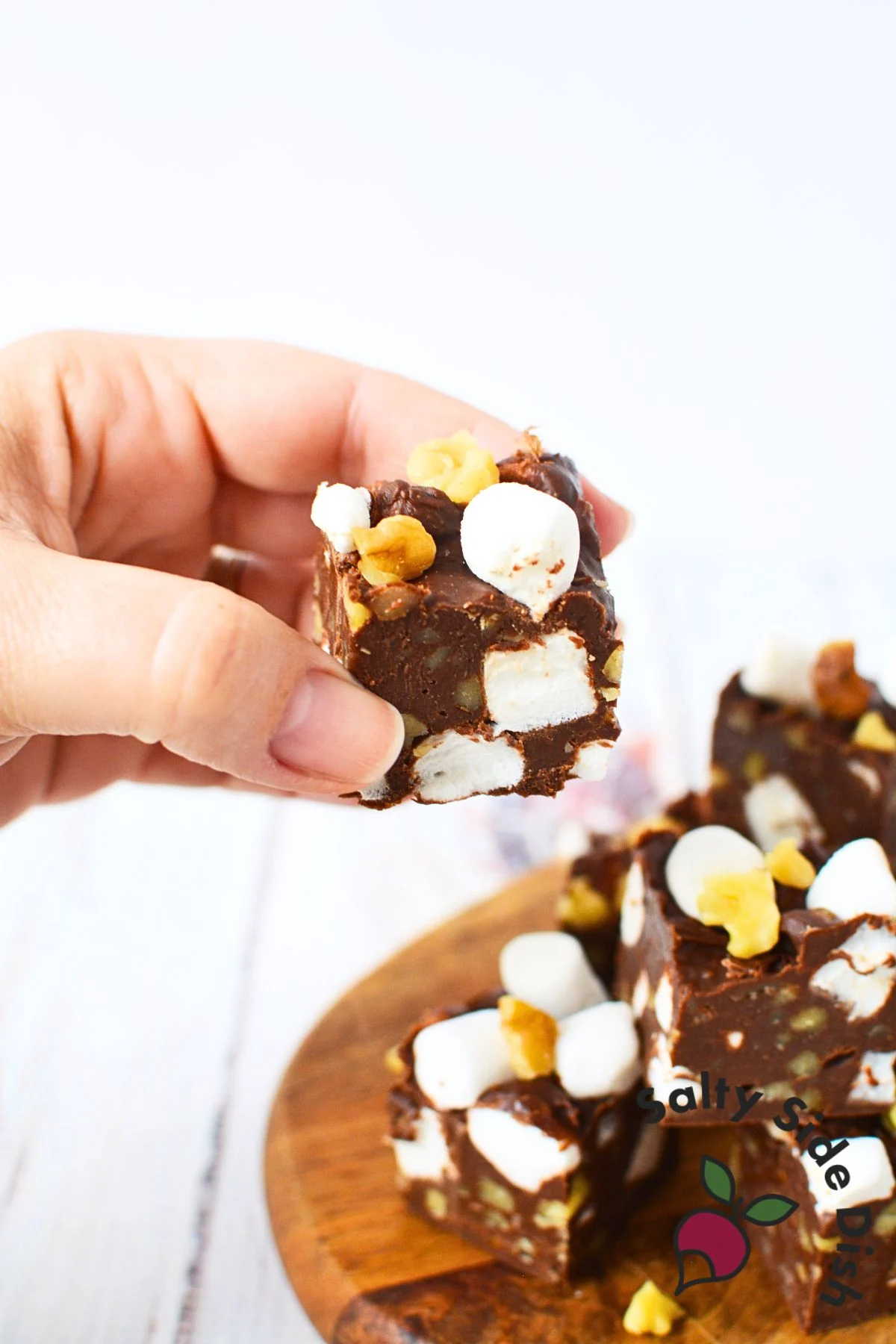 a piece of homemade rocky road fudge being held.