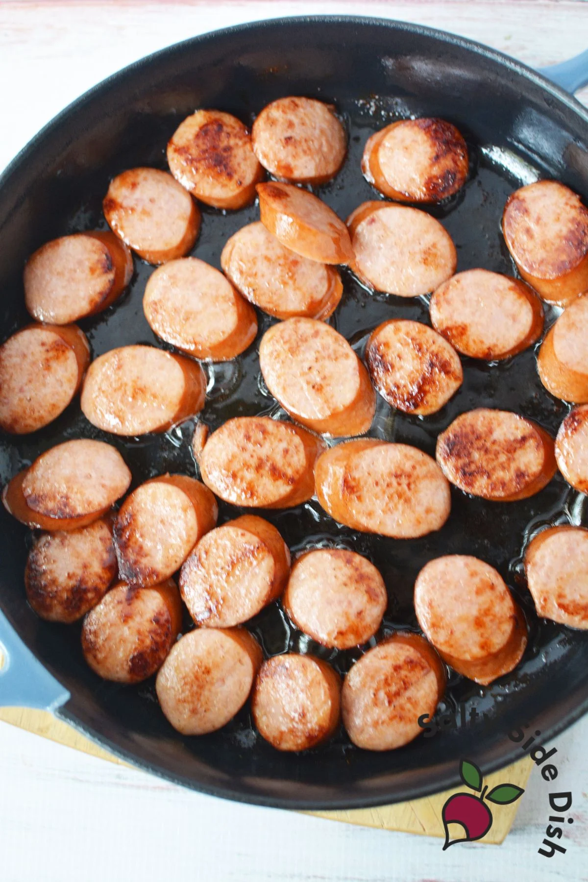 cooking sausage in a cast iron skillet.