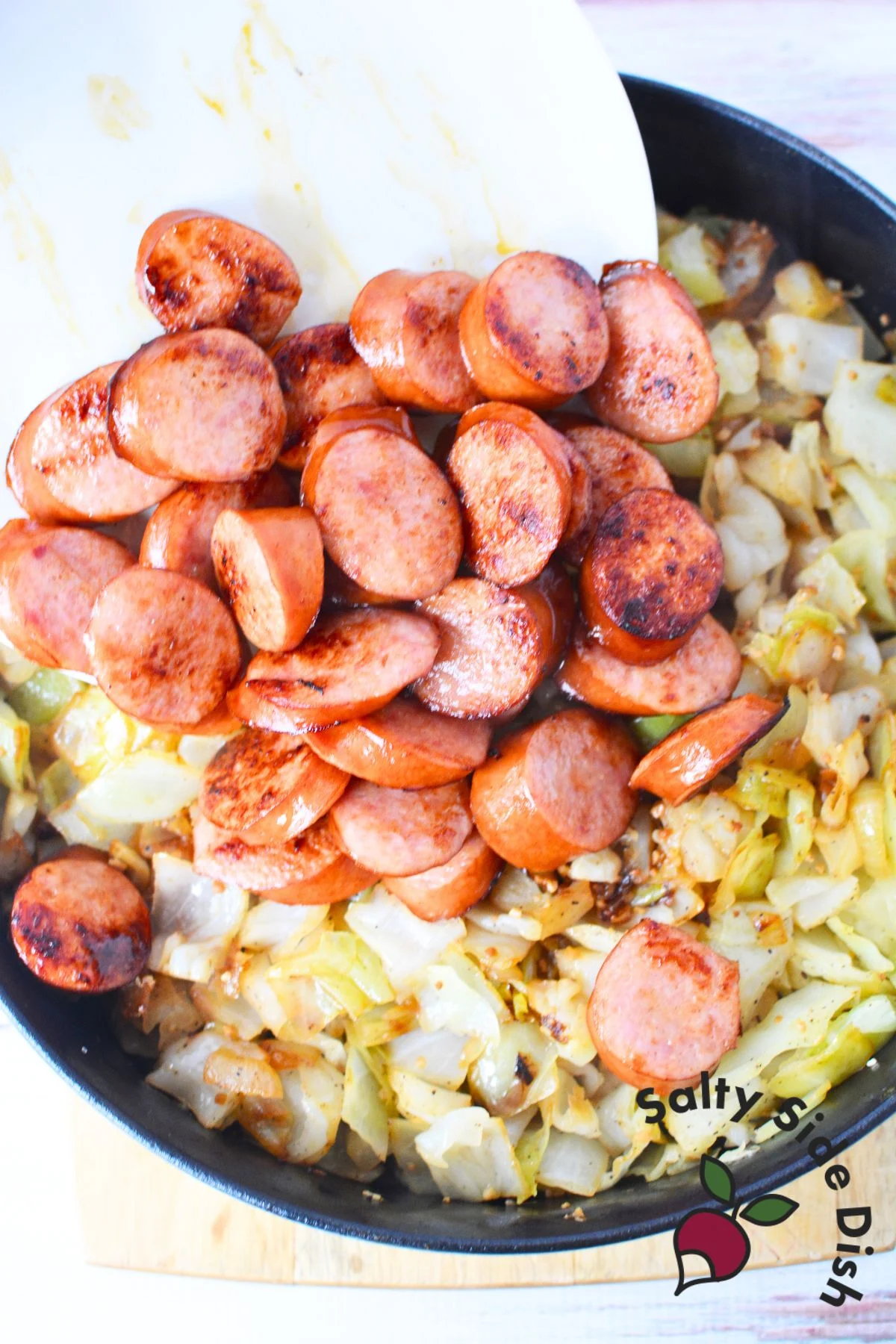 combining sausage with cabbage.