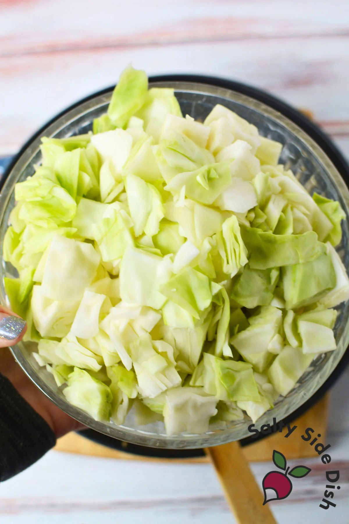 uncooked chopped cabbage in a bowl.
