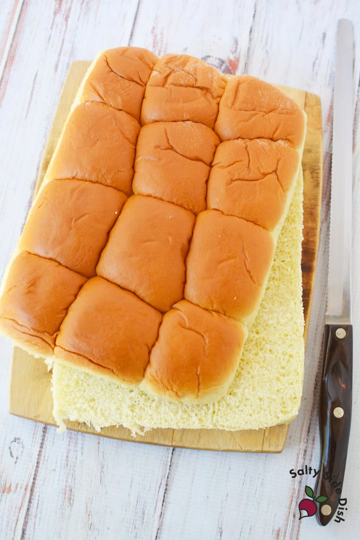 cutting kings hawaiian brand rolls into sheets.