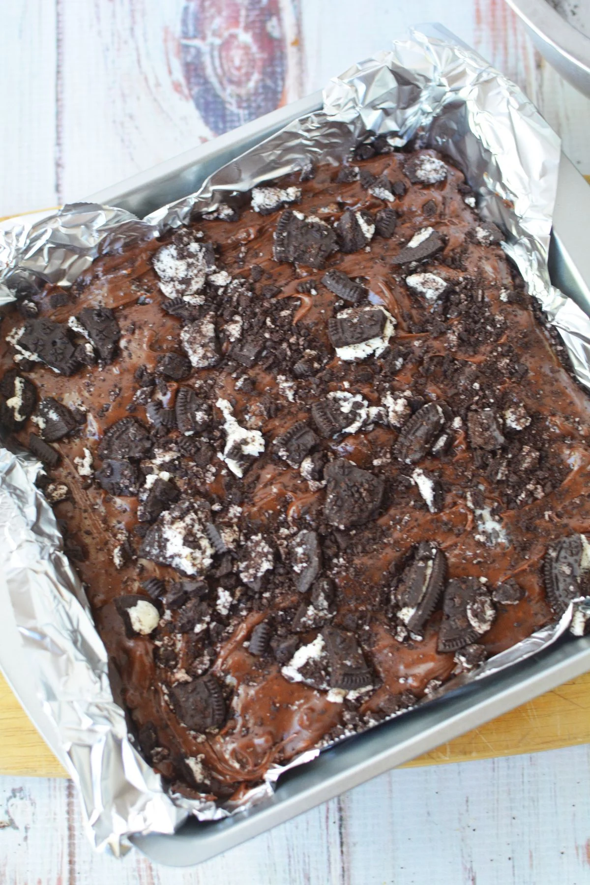 pressing oreo pieces into the top of fudge.