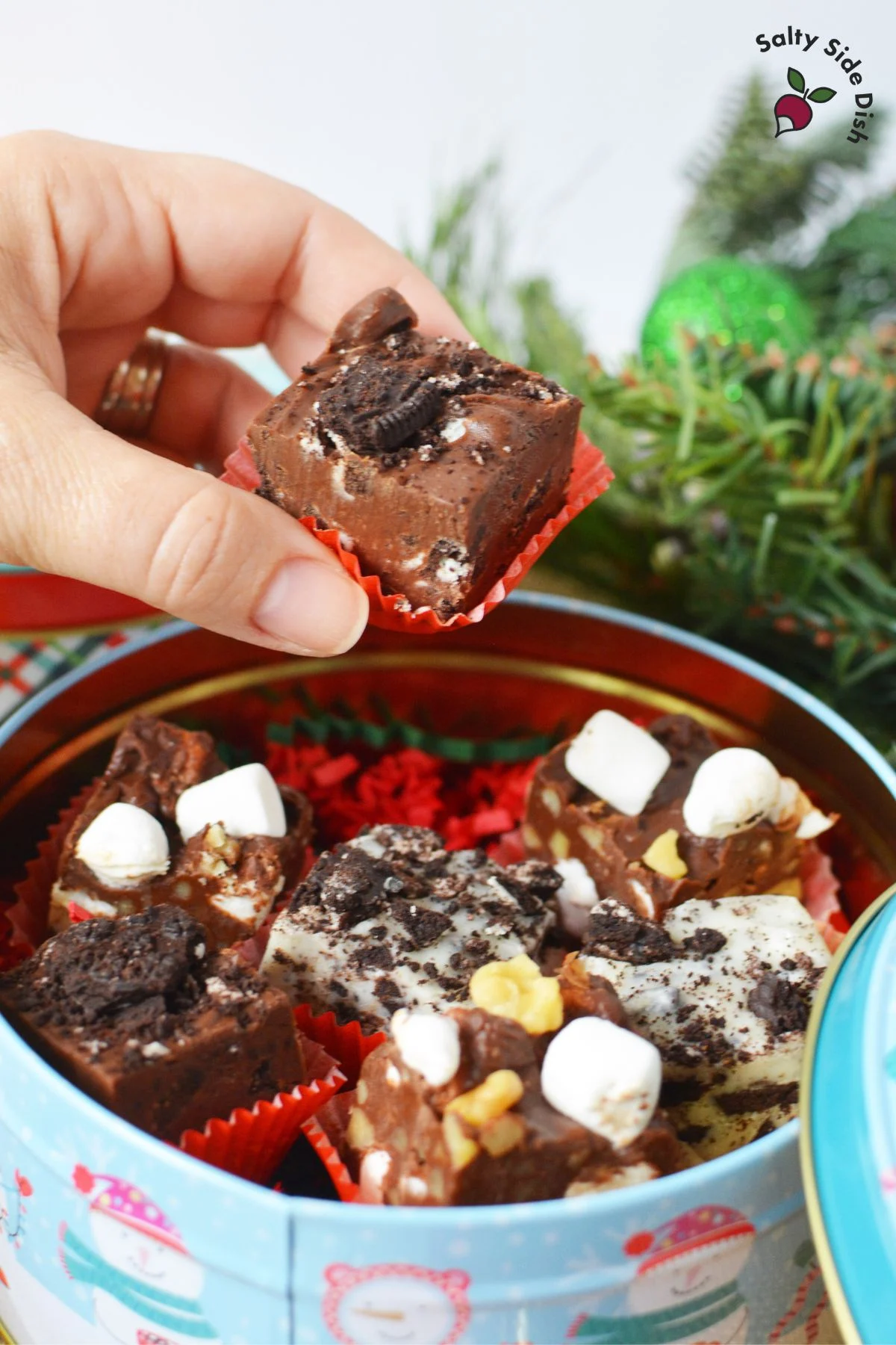 packing homemade fudge in tins for gifting.