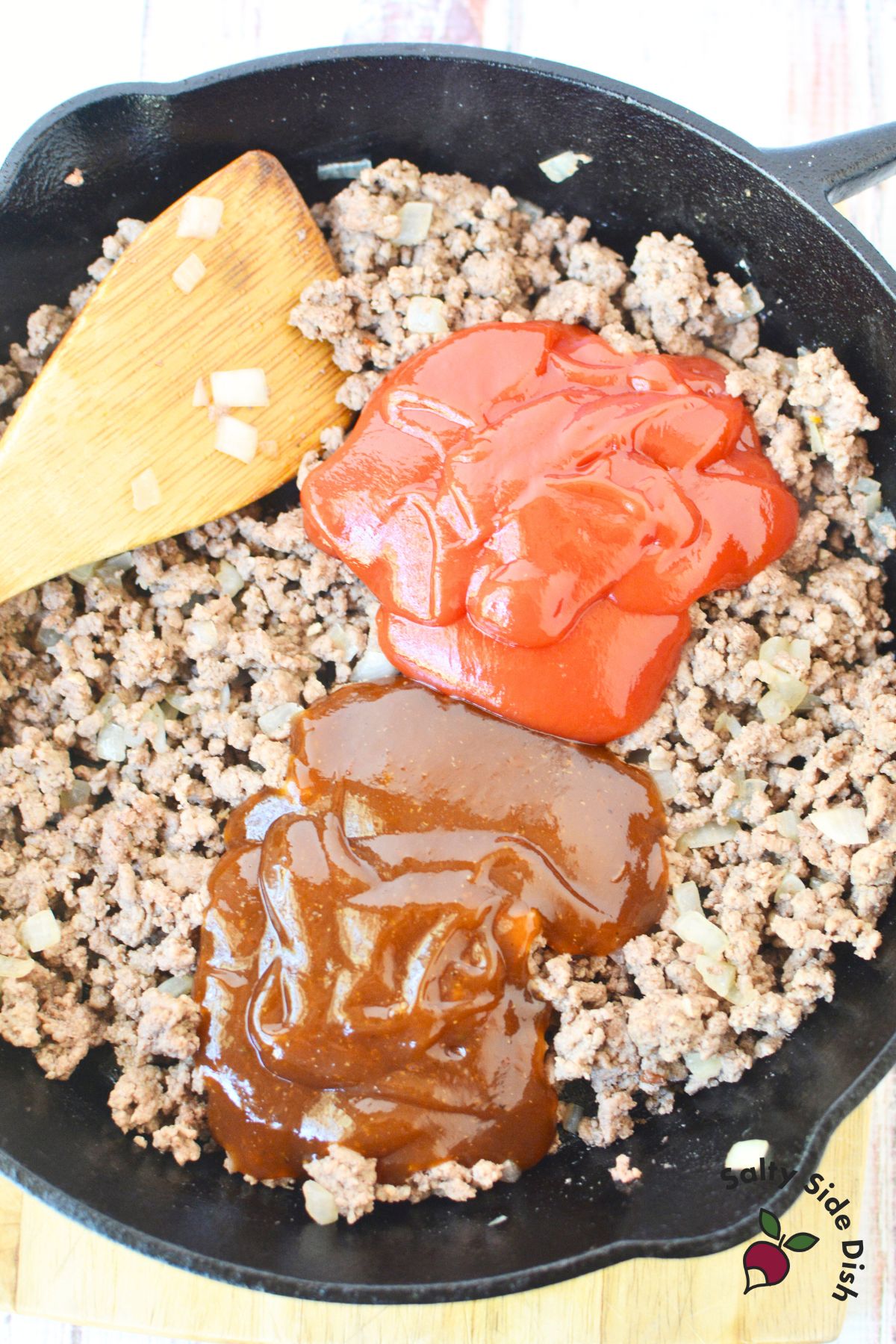 sloppy joe sauce recipe in a cast iron pan.
