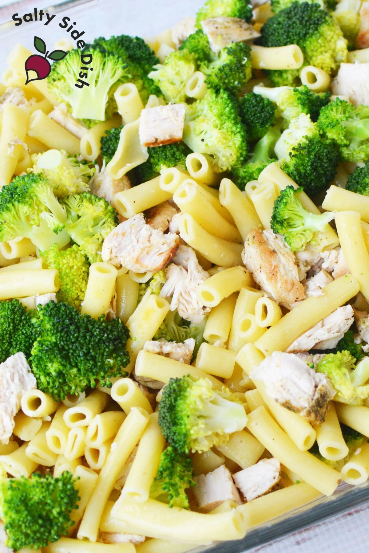 Combine broccoli, chicken, and cooked ziti in a baking dish.