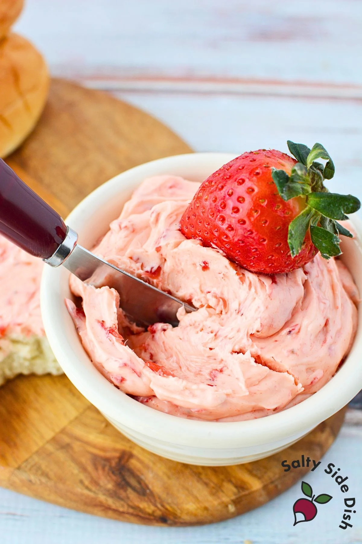 knife inside strawberry butter ready to use it.