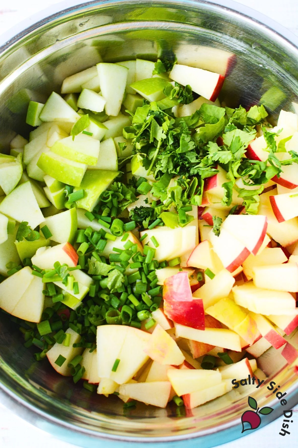 sliced apples and strawberries in a mixing bowl.